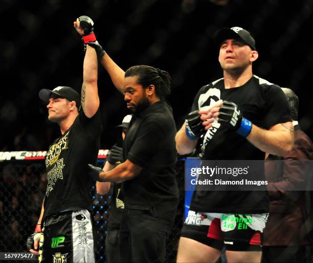 Michael Bisping has his arm raised in victory after beating Alan Belcher after a middleweight bout during UFC 159 Jones v. Sonnen at Prudential...