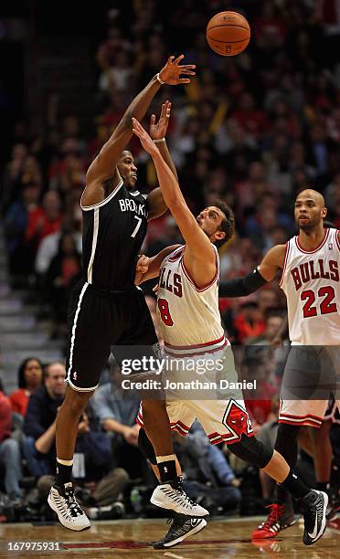 Joe Johnson of the Brooklyn Nets passes over Marco Belinelli of the Chicago Bulls in Game Six of the Eastern Conference Quarterfinals during the 2013...