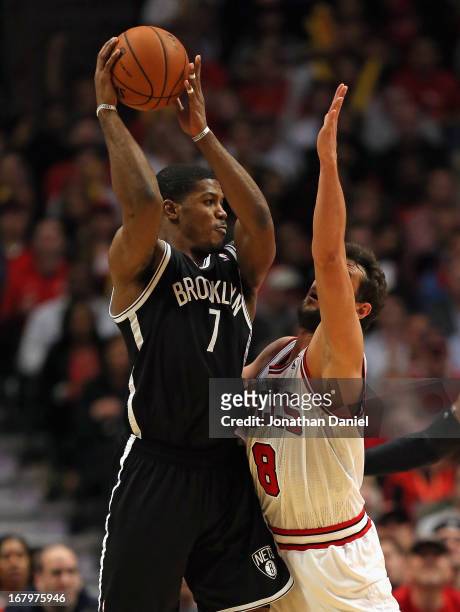 Joe Johnson of the Brooklyn Nets looks to pass over Marco Belinelli of the Chicago Bulls in Game Six of the Eastern Conference Quarterfinals during...
