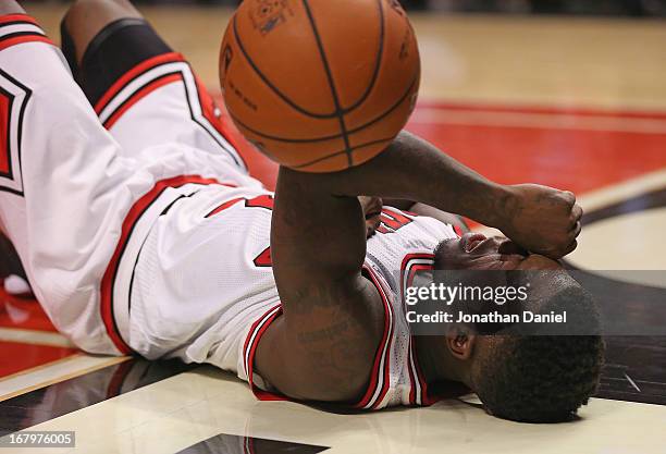 Nate Robinson of the Chicago Bulls lays on the floor after being fouled while driving to the basket against the Brooklyn Nets in Game Six of the...