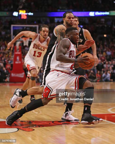 Nate Robinson of the Chicago Bulls drives past Deron Williams of the Brooklyn Nets in Game Six of the Eastern Conference Quarterfinals during the...