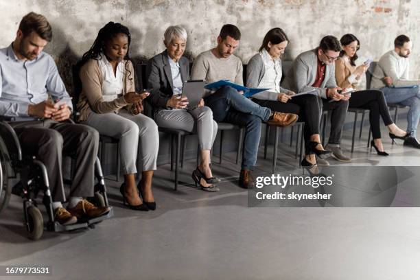 business people anticipating job interview in waiting room. - people in a row stock pictures, royalty-free photos & images