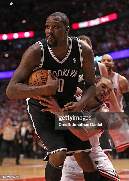 Joakim Noah of the Chicago Bulls grabs Andray Blatche of the Brooklyn Nets in Game Six of the Eastern Conference Quarterfinals during the 2013 NBA...