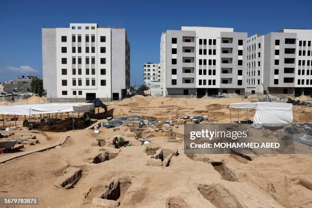 Worker sifts through the soil as excavations continue at the site discovered in 2022, of a cemetery dating from the Roman era, in Beit Lahia in the...