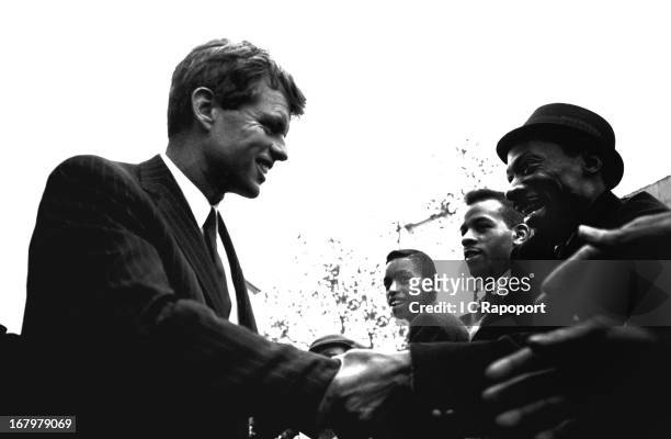Former US Attorney General Bobby Kennedy shakes hands with potential voters on 125th Street in Harlem during his run for the US Senate seat for NY in...