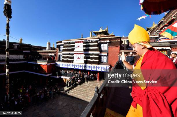 The 11th Panchen Lama Bainqen Erdini Qoigyijabu waves to worshippers and tourists at the Tashilhunpo Monastery, the traditional seat of the Panchen...