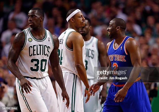 Raymond Felton of the New York Knicks smiles as Brandon Bass and Paul Pierce of the Boston Celtics react during Game Six of the Eastern Conference...
