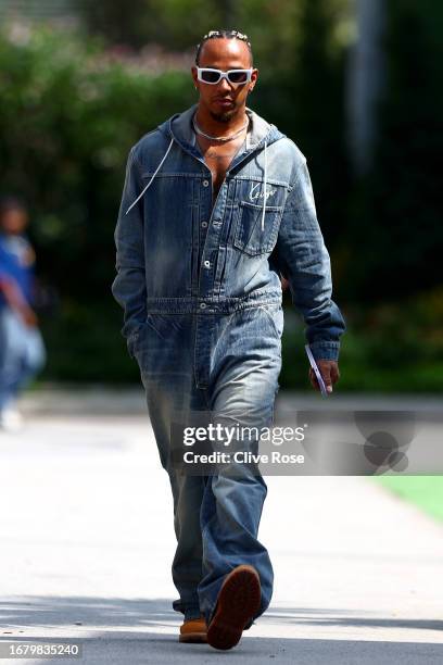 Lewis Hamilton of Great Britain and Mercedes walks in the Paddock during previews ahead of the F1 Grand Prix of Singapore at Marina Bay Street...