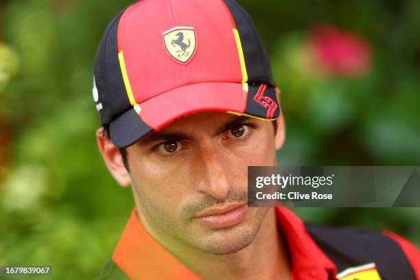 Carlos Sainz of Spain and Ferrari looks on in the Paddock during previews ahead of the F1 Grand Prix of Singapore at Marina Bay Street Circuit on...