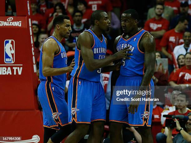 Serge Ibaka of the Oklahoma City Thunder tries to clam down his teammate Kendrick Perkins as Thabo Sefolosha looks on during the game against the...
