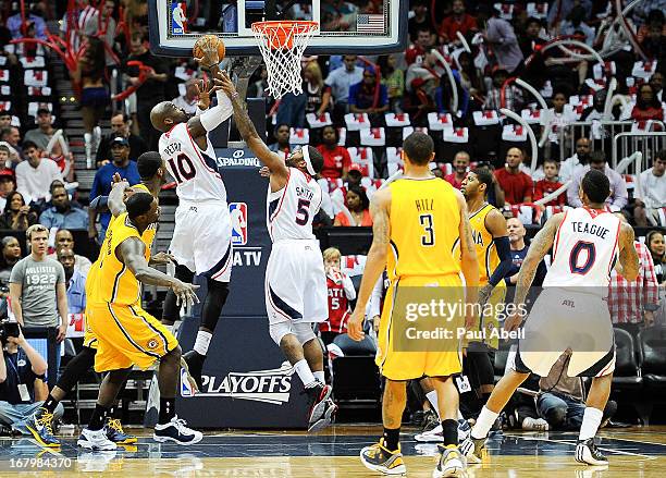 Johan Petro and Josh Smith of the Atlanta Hawks grab a rebound during the first half against the Indiana Pacers at Philips Arena on May 3, 2013 in...