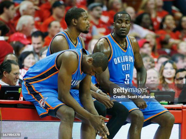 Serge Ibaka, Kevin Durant and Kendrick Perkins of the Oklahoma City Thunder wait to enter the game against the Houston Rockets in Game Six of the...