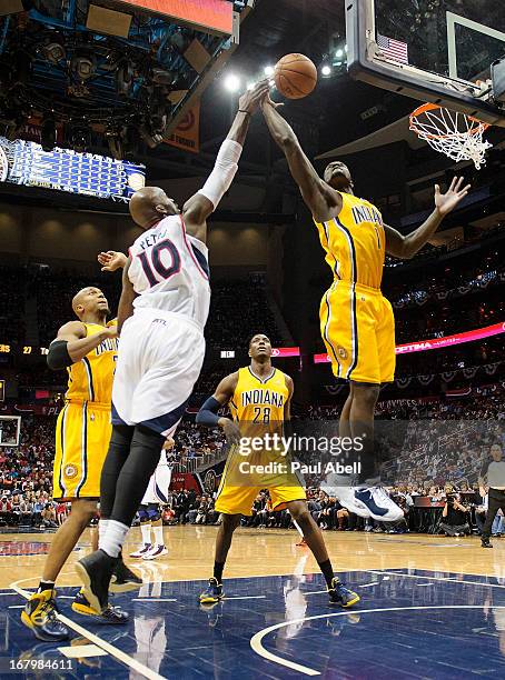 Lance Stephenson of the Indiana Pacers and Johan Petro of the Atlanta Hawks fight for a rebound during the second half at Philips Arena on May 3,...