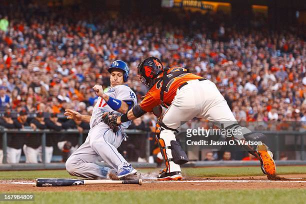 Buster Posey of the San Francisco Giants tags out A.J. Ellis of the Los Angeles Dodgers at home plate during the second inning at AT&T Park on May 3,...