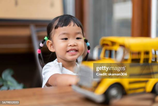 asian toddler enjoy playing toys with mother at home - snakes and ladders stock pictures, royalty-free photos & images