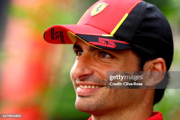 Carlos Sainz of Spain and Ferrari looks on in the Paddock during previews ahead of the F1 Grand Prix of Singapore at Marina Bay Street Circuit on...
