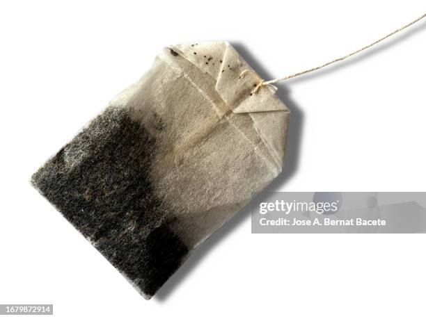 infusion of grasses of tea (tea bag ) on a white background with a small shadow. - herbal tea bag stock pictures, royalty-free photos & images