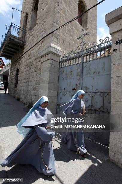 Two nuns walk past the Hospice of the Daughters of Charity of St. Vincent de Paul complex in Jerusalem on May 6, 2009. Israeli and Vatican lawyers...