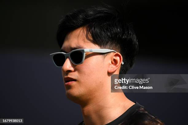 Zhou Guanyu of China and Alfa Romeo F1 walks in the Paddock during previews ahead of the F1 Grand Prix of Singapore at Marina Bay Street Circuit on...