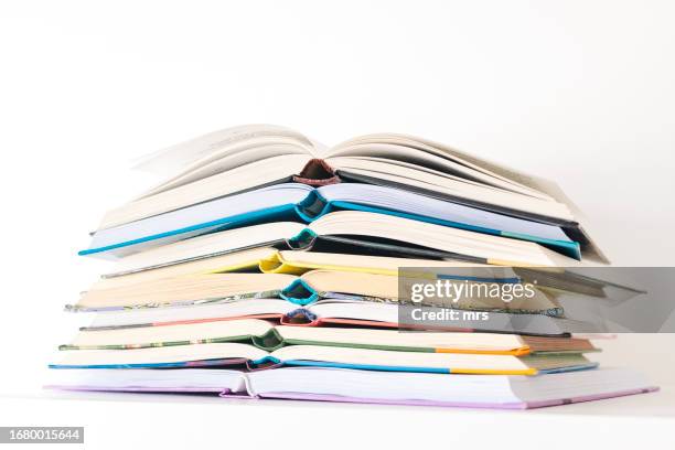stack of open books on table - pile of books white background stockfoto's en -beelden
