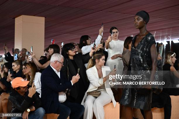 Guests film with their mobile phones the Prada fashion show during the Milan Fashion Week Womenswear Spring/Summer 2024 on September 21, 2023 in...