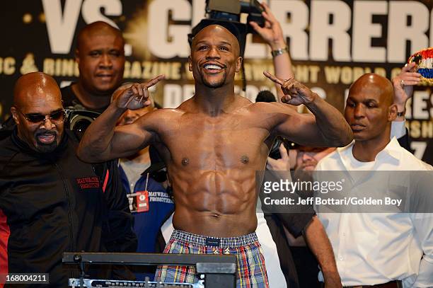 Boxer Floyd Mayweather Jr. Poses on the scale during the official weigh-in for his welterweight bout against Robert Guerrero at the MGM Grand Garden...