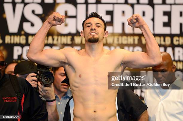 Boxer Robert Guerrero poses on the scale during the official weigh-in for his welterweight bout against Floyd Mayweather Jr. At the MGM Grand Garden...