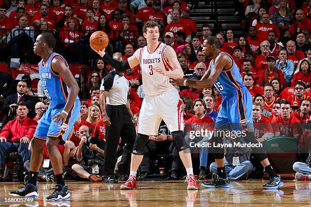 Omer Asik of the Houston Rockets looks to pass the ball against Kevin Durant of the Oklahoma City Thunder in Game Six of the Western Conference...