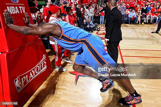 Serge Ibaka of the Oklahoma City Thunder stretches before playing against the Houston Rockets in Game Six of the Western Conference Quarterfinals...