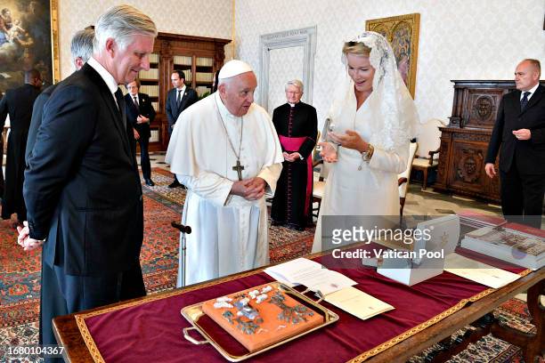 Pope Francis exchanges gifts with King Philippe And Queen Mathilde of Belgium during an audience at the Apostolic Palace on September 14, 2023 in...