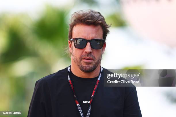 Fernando Alonso of Spain and Aston Martin F1 Team walks in the Paddock during previews ahead of the F1 Grand Prix of Singapore at Marina Bay Street...