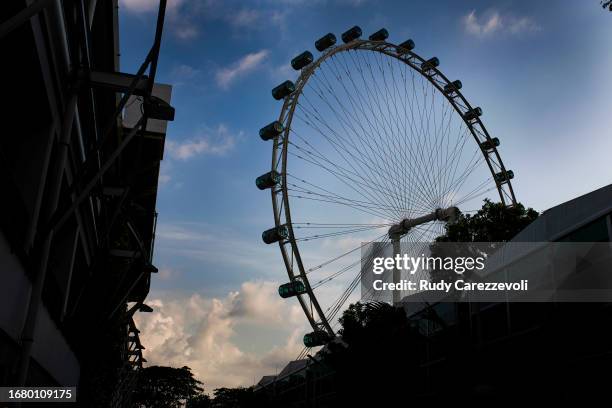 The Singapore Flyer is seen over the paddock during previews ahead of the F1 Grand Prix of Singapore at Marina Bay Street Circuit on September 14,...