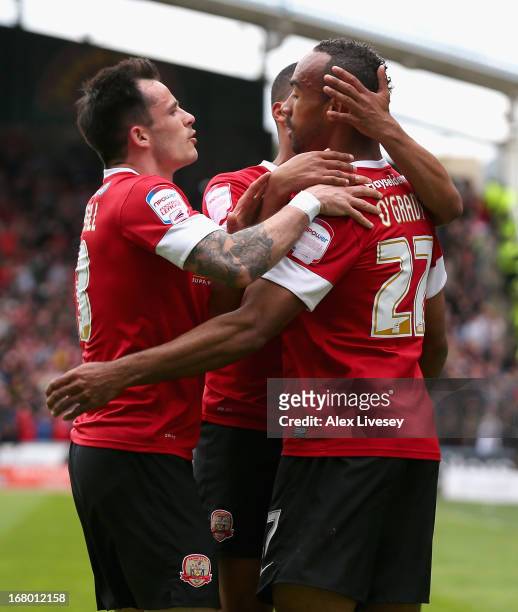 Chris O'Grady of Barnsley celebrates scoring the opening goal with teammates during the npower Championship match between Huddersfield Town and...