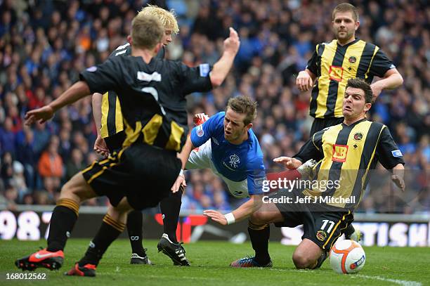 David Templeton of Rangers is tackled by Kevin McDonald of Berwick Rangers during the IRN-BRU Scottish Third Division match at Ibrox Stadium on May...