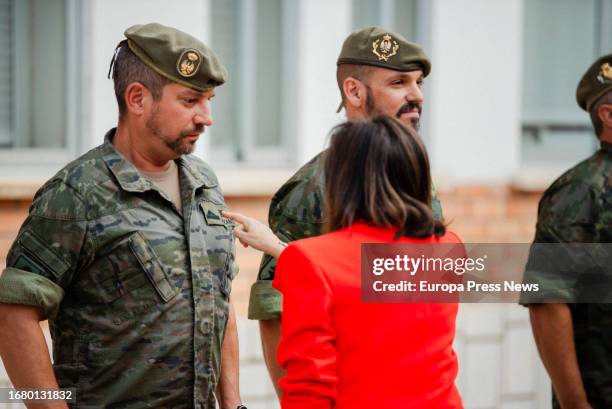 Acting Minister of Defense, Margarita Robles, points to the insignia of the specialist in repairs and maintenance of tanks and other army vehicles,...