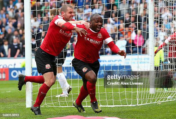 Jason Scotland of Barnsley celebrates scoring his side's second goal with team mates during the npower Championship match between Huddersfield Town...