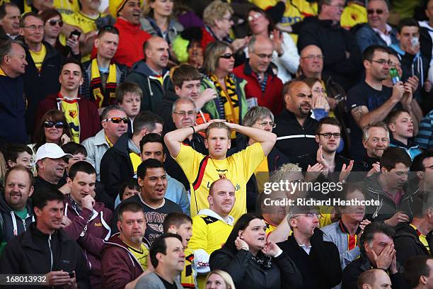 Watford fan looks on anxiously after hearing the result between Hull City and Cardiff City during the npower Championship match between Watford and...