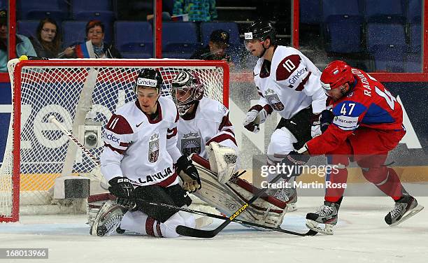 Alexander Radulov of Russia and Kristaps Sotnieks of Latvia battle for the puck during the IIHF World Championship group H match between Russia and...
