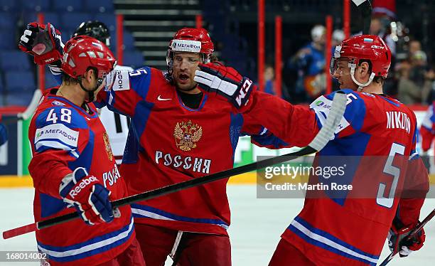 Yevgeni Biryukov of Russia celebrate with Alexander Svitov and Ilya Nikulin after he scores his team's opening goal during the IIHF World...