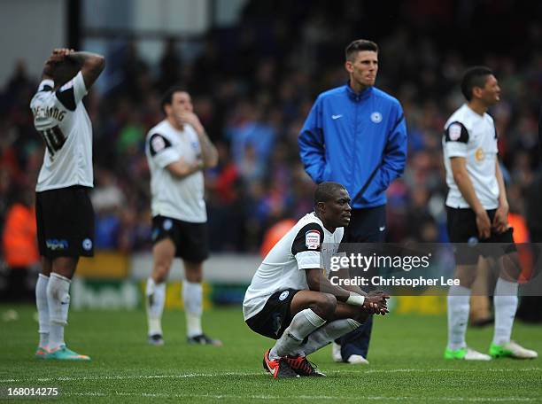 Gabriel Zakuani of Peterborough looks dejected with his team mates after they are relegated during the npower Championship match between Crystal...