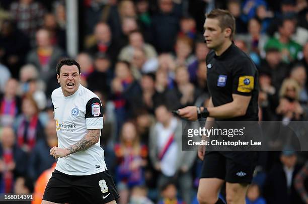Lee Tomlin of Peterborough shouts towards the referee Craig Pawson after Palace score their winning goal during the npower Championship match between...