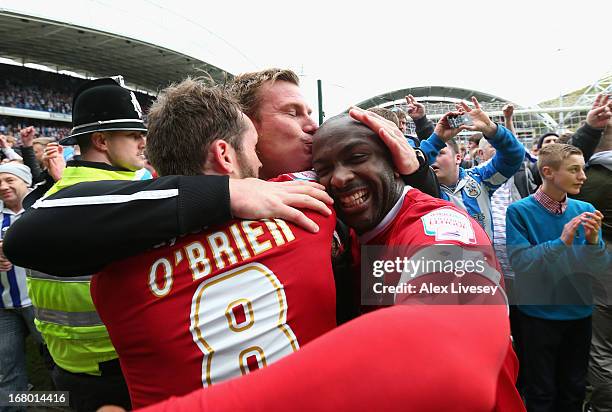 Barnsley manager David Flitcroft celebrates survival with Jim O'Brien and Jason Scotland at the end of the npower Championship match between...