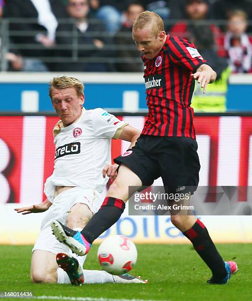 Sebastian Rode of Frankfurt is challenged by Axel Bellinghausen of Duesseldorf during the Bundesliga match between Eintracht Frankfurt and Fortuna...