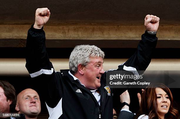 Steve Bruce the Hull manager celebrates following his team's promotion to the Premier League during the npower Championship match between Hull City...