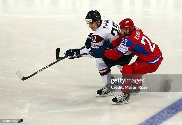 Denis Kokarev of Russia and Arturs Kulda of Latvia battle for the puck during the IIHF World Championship group H match between Russia and Latvia at...