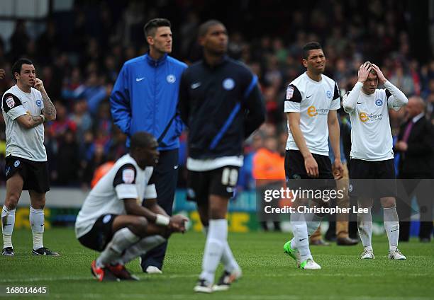 Lee Tomlin and Grant McCann of Peterborough with team mates looks dejected after they are relegated during the npower Championship match between...