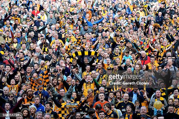 Hull fans fans run onto the pitch to celebrate their team's promotion to the Premier League during the npower Championship match between Hull City...
