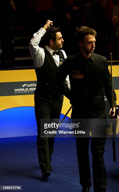 Ronnie O'Sullivan of England celebrates beating Judd Trump of England during the Semi Final match of the Betfair World Snooker Championship at the...