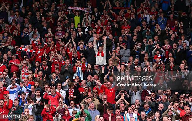 Barnsley supporters celebrate after the npower Championship match between Huddersfield Town and Barnsley at John Smith's Stadium on May 04, 2013 in...