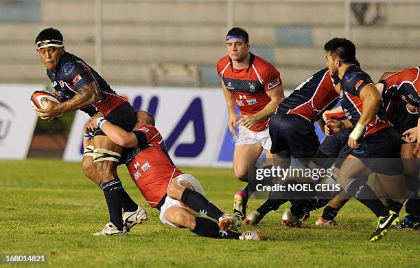 Rugby player Christopher Hitch of Philippines is tackled by Hong Kong rugby player Peter Mckee during their Rugby Asian Five-Nations match at the...